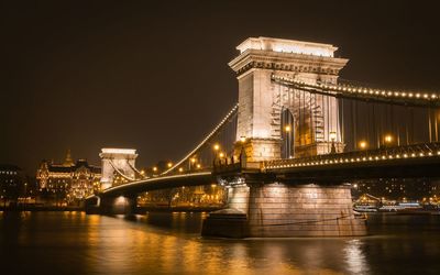 Low angle view of suspension bridge at night