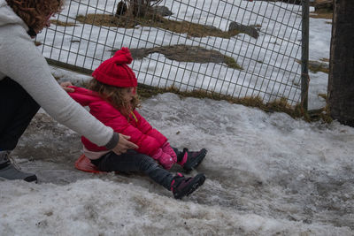 Low section of man exercising on snow