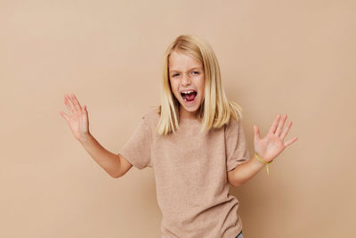 Portrait of smiling young woman against pink background