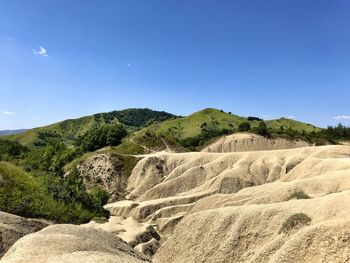 Scenic view of mountains against clear blue sky