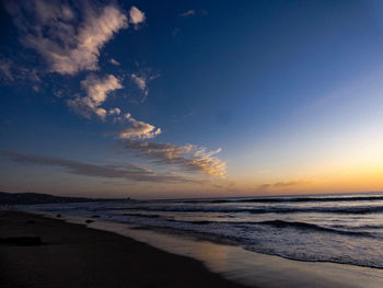 Scenic view of beach against sky during sunset