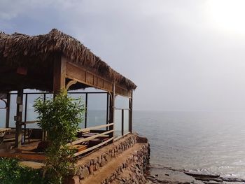 Built structure on beach against sky