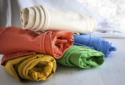 Close-up of colorful pants rolled on table