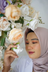 Midsection of woman with bouquet