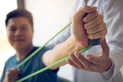 Physical therapist assisting patient in exercising at hospital