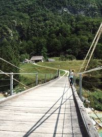 Man walking on footbridge