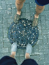 Low section of woman standing on tiled floor