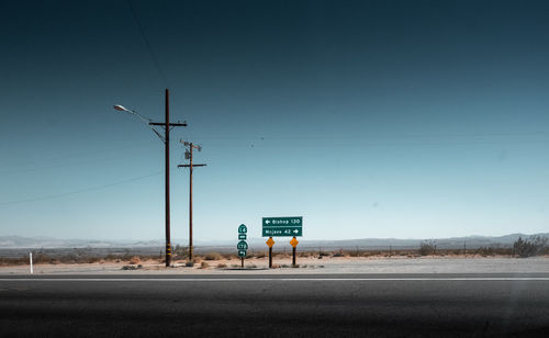 Road sign against sky