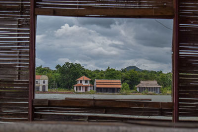 View of railroad tracks by building against sky