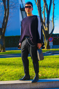 Full length of young man standing by plants