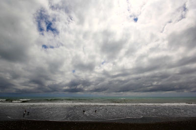 Scenic view of sea against storm clouds