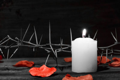 Close-up of lit candles on table