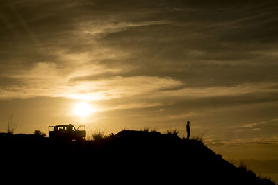 Silhouette landscape against sky during sunset