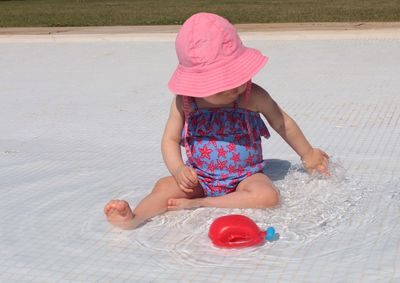 Full length of girl playing in water