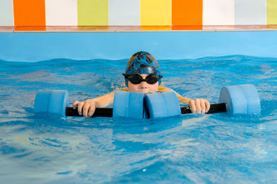 Portrait of boy swimming in pool