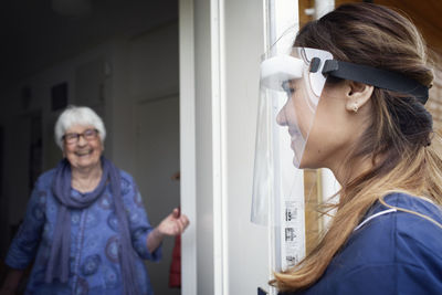 Nurse entering woman's house