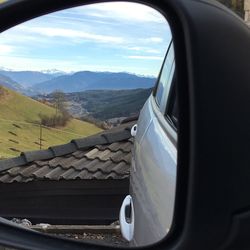 Close-up of car on landscape against sky