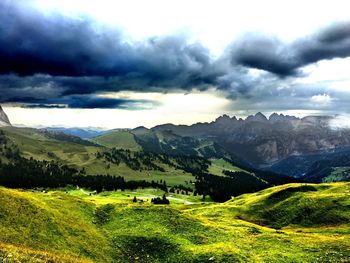 Scenic view of mountains against cloudy sky