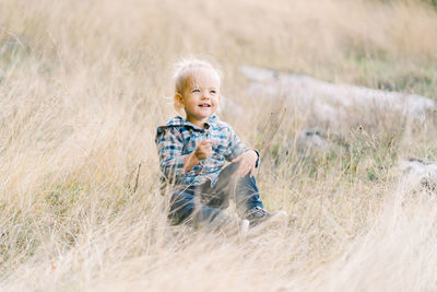 Portrait of boy standing on field