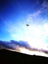 Silhouette landscape against blue sky