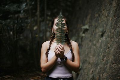 Rear view of woman standing against trees