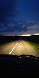 Road against sky seen through car windshield