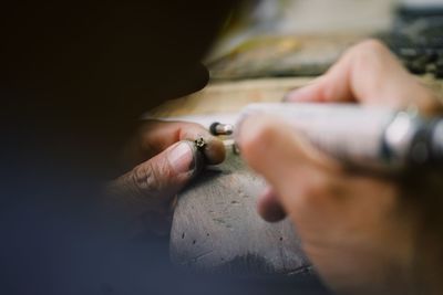 Close-up of hand holding cigarette