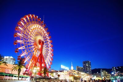 Low angle view of ferris wheel at night