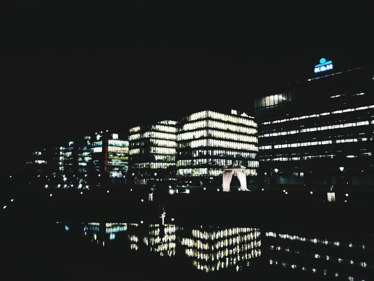 ILLUMINATED MODERN CITYSCAPE AT NIGHT