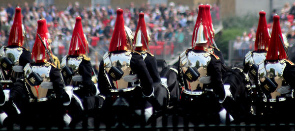 Close-up of people sitting on horse