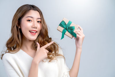 Portrait of a beautiful young woman over white background