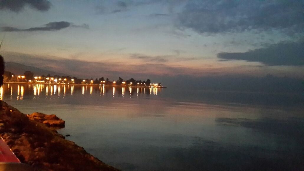 water, sky, architecture, illuminated, built structure, reflection, sea, building exterior, sunset, dusk, waterfront, cloud - sky, night, pier, cloud, scenics, outdoors, tranquility, tranquil scene, nature