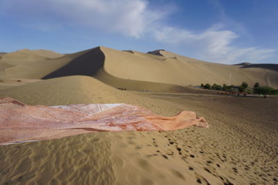 Fabric on sand at desert during sunny day