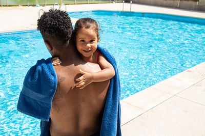 Portrait of shirtless boy swimming in pool