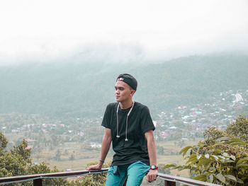 Young man looking at cityscape