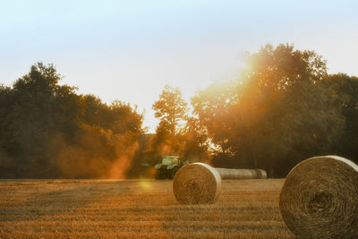 Hay bales on field against sky