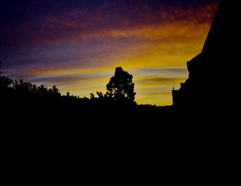 Silhouette landscape against sky during sunset