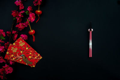 Chinese lunar new year decoration over black background. flat lay dinning table concept.