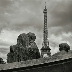 Low angle view of eiffel tower against cloudy sky