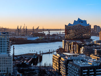 High angle view of buildings in city at sunset