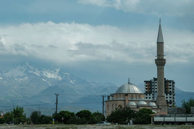 View of mosque against cloudy sky