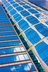 Low angle view of modern building against blue sky