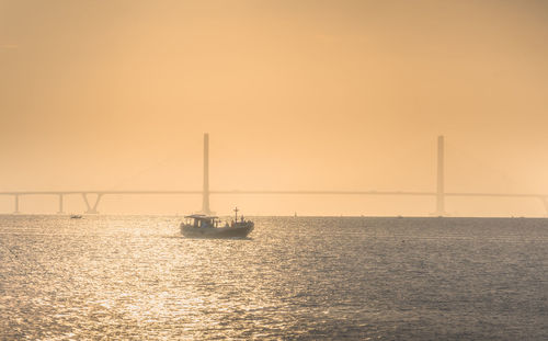 Sailboat on sea against sky during sunset