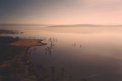 Scenic view of lake against sky at sunset