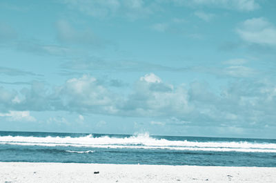 Scenic view of sea against cloudy sky