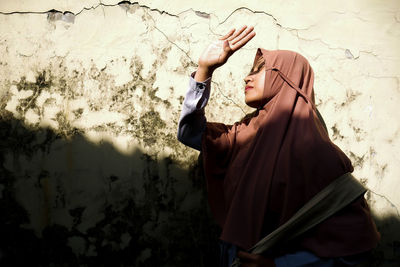 A veiled woman in the glare of the light.