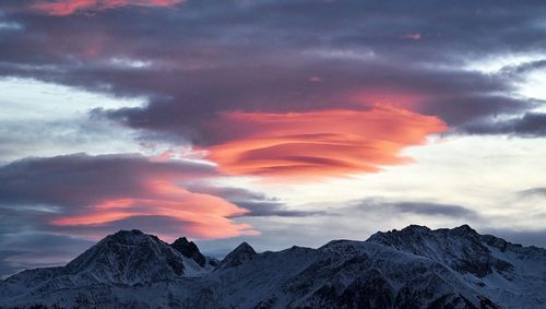 Scenic view of snowcapped mountains against sky during sunset