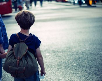 Woman standing on road in city