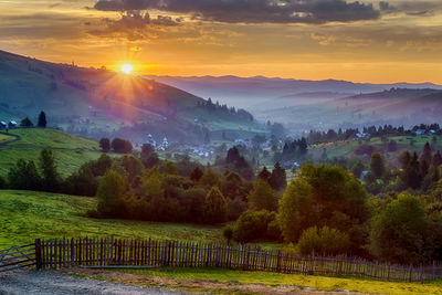 Scenic view of field against sky during sunset