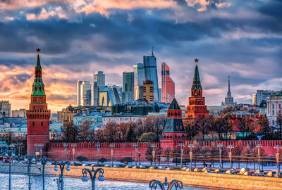 Buildings in city against cloudy sky